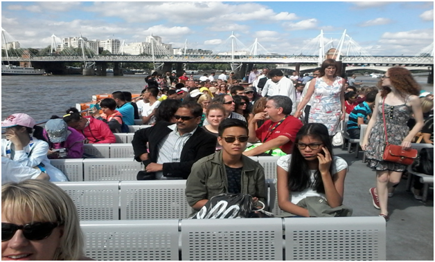 Tourists on sightseeing cruise on the Thames